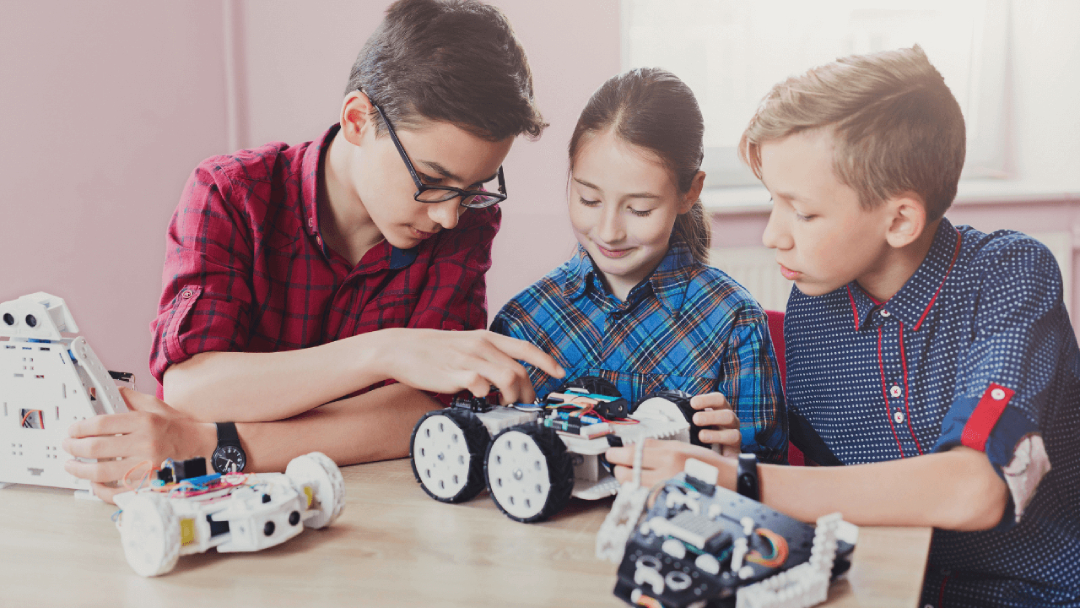 Kids playing a STEM game together with robotics