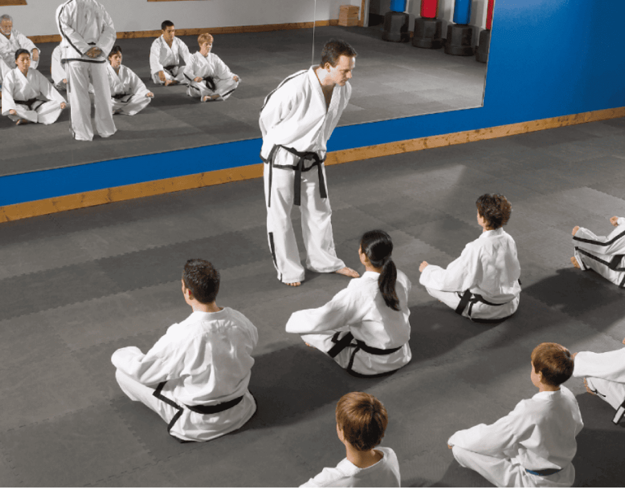 Teens in a karate class, practicing one of the best martial arts for a teenager.