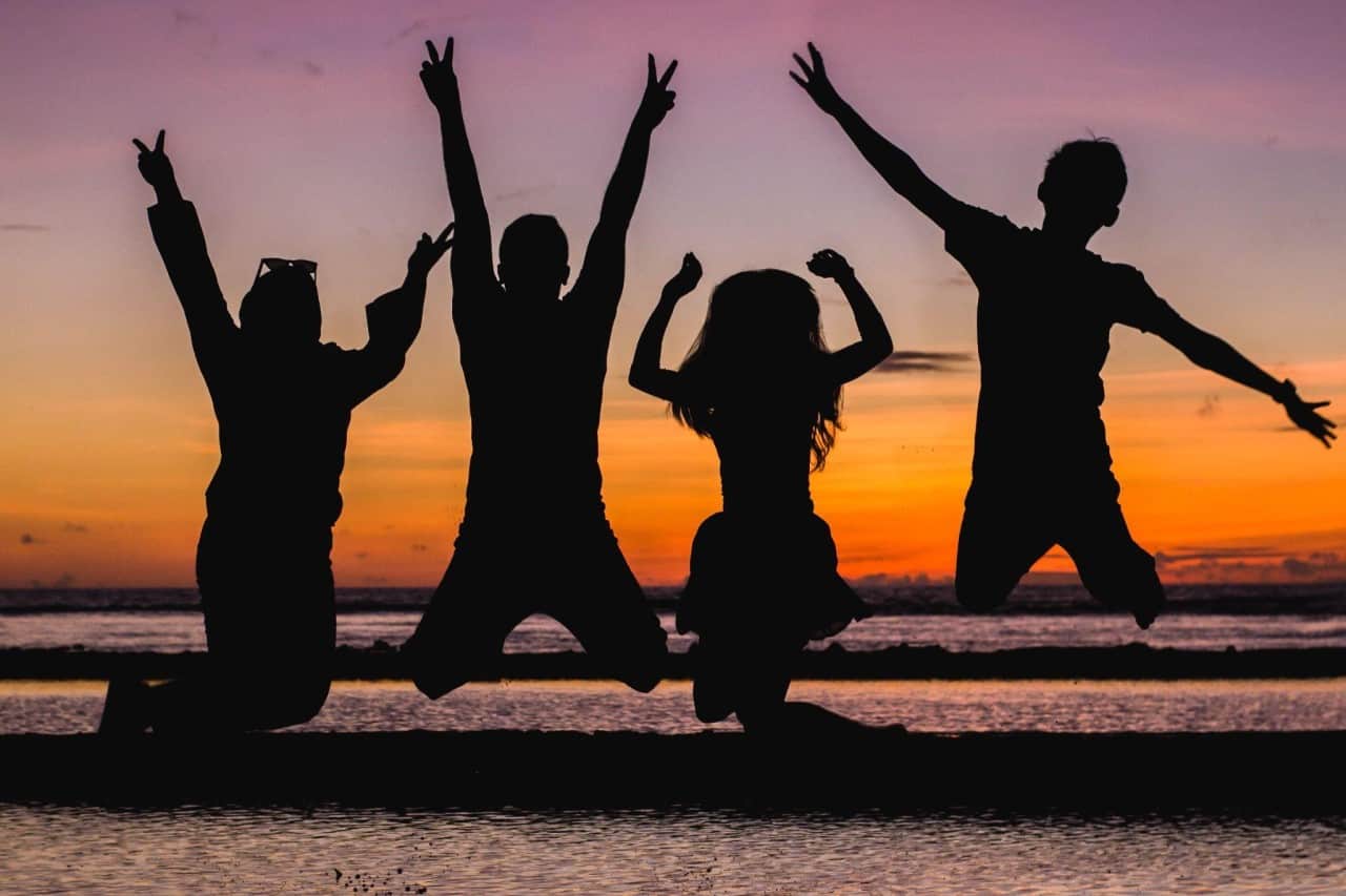 silhouette of teens at a beach summer camp
