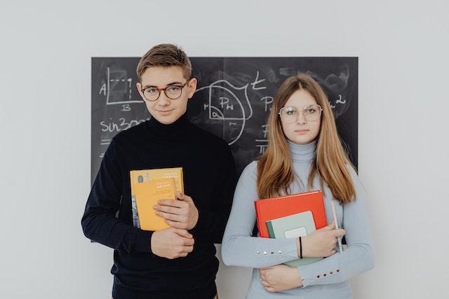 Two Math Students Standing in Front of the Blackboard