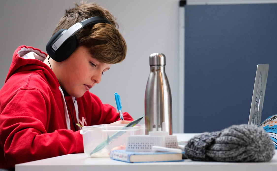 Teen studying with headphones